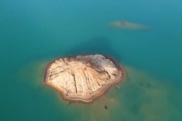 Quarry for mining and enrichment of titanium and other rare ores. Blue water in the enrichment tank.