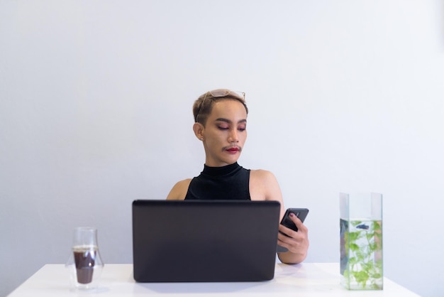 Queer LGBT community supporter man with mustache working in office coffee and notebooks on desk