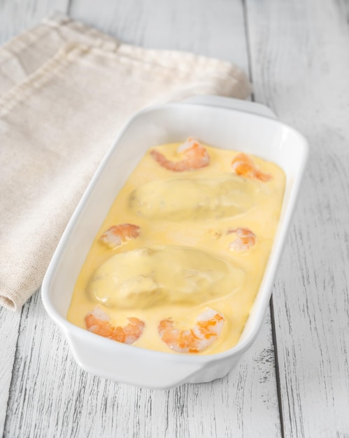 Quenelle creamed fish mixture with Hollandaise sauce