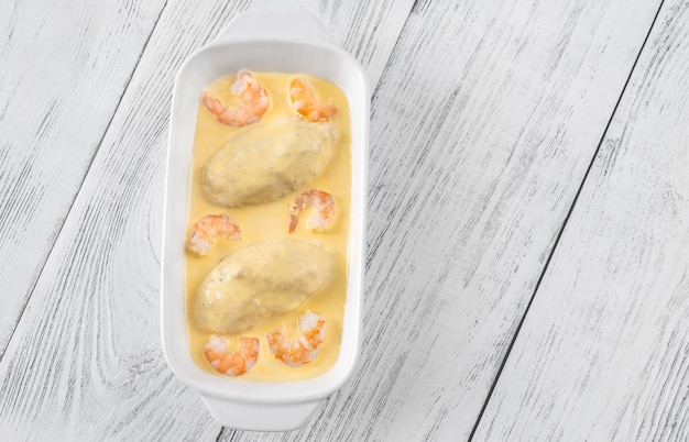 Quenelle creamed fish mixture with Hollandaise sauce