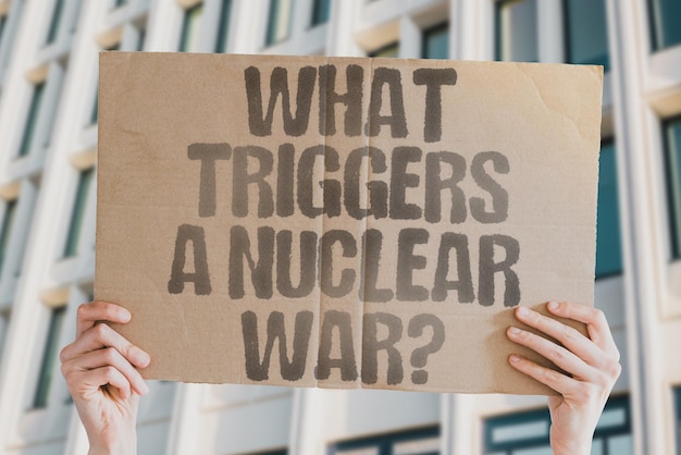 The question Can nuclear war be won is drawn on a carton banner in men's hands Strategy Power Leadership Global Political Military Army Navy Air Force Security Safety Emergency