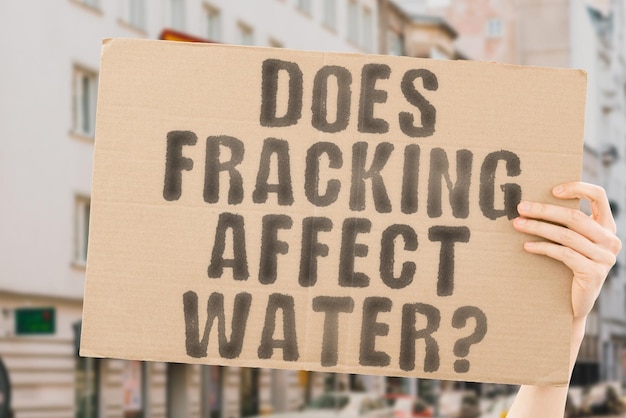 The question Does fracking affect water on a banner in men's hands with blurred background Climate Ecological Business Ecologic Safety Drill Nature Geology Caution Health Healthiness