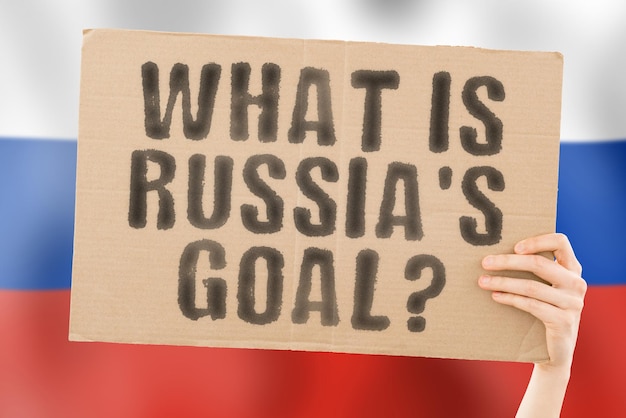 The question What is Russia's goal on a banner in men's hand with blurred Russian flag on the background Work Rules Trade Law Judge Import Force Court Crime Choice Office Nation