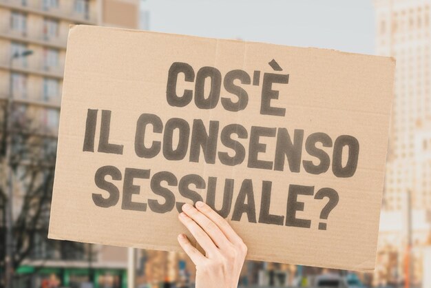 The question What is sexual consent on a banner in men's hands with blurred background Intimacy Intimate Sex Adult Law Relationship Love Legality