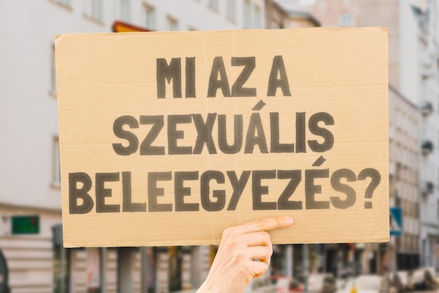 The question What is sexual consent on a banner in men's hands with blurred background Intimacy Intimate Sex Adult Law Relationship Love Legality