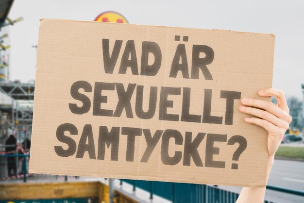 The question What is sexual consent on a banner in men's hands with blurred background Intimacy Intimate Sex Adult Law Relationship Love Legality