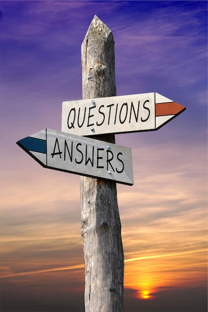 Questions and answers signpost with two arrows sunset sky in background