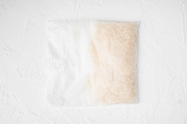 Quick cooking rice bag set on white stone table background top view flat lay