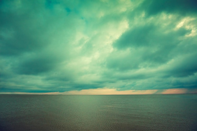 Quiet calm sea with the cloudy sky at sunset