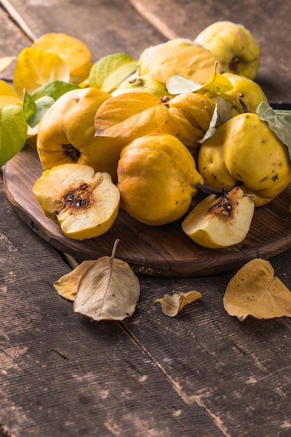 Quince fruits on a wooden background. Harvest of autumn fruits.