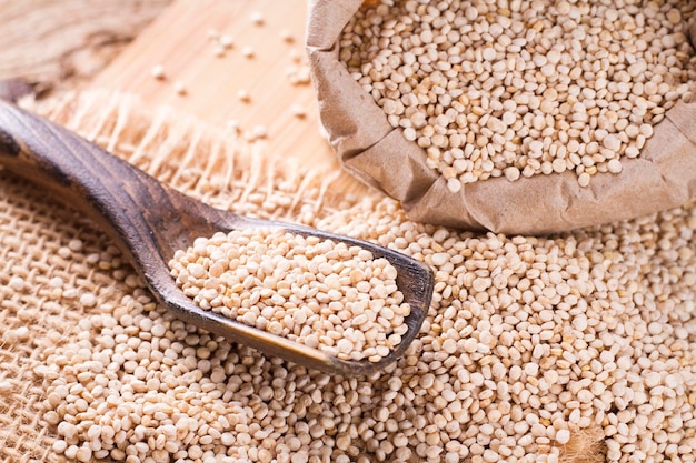 Quinoa beans in bowl on wooden background