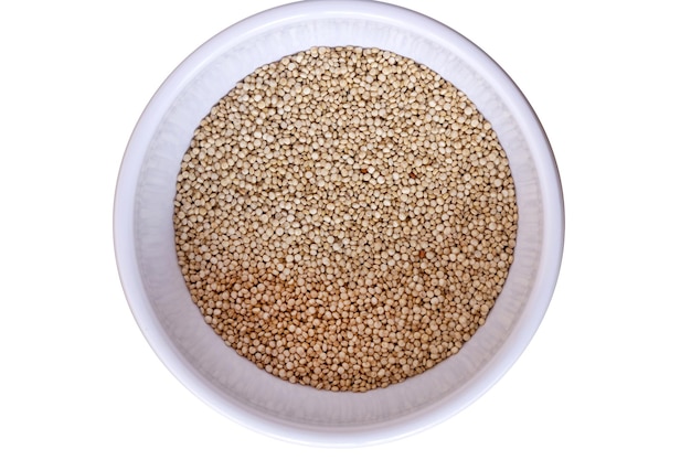 Quinoa in grain on bowl Top view white background