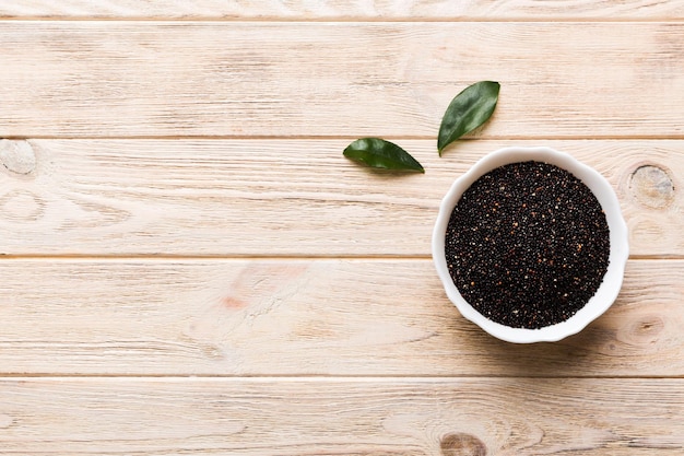 Quinoa seeds in bowl on colored background Healthy kinwa in small bowl Healthy superfood