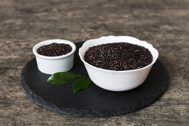 Quinoa seeds in bowl on colored background Healthy kinwa in small bowl Healthy superfood