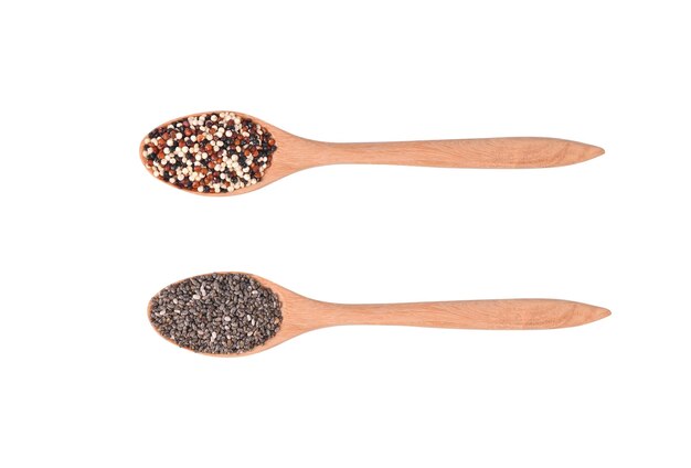 Quinoa seeds and chia seeds in wooden spoon isolated on background top view