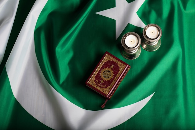 Quran and candles on a flag of Pakistan Translation into English the book contains verses of Koran