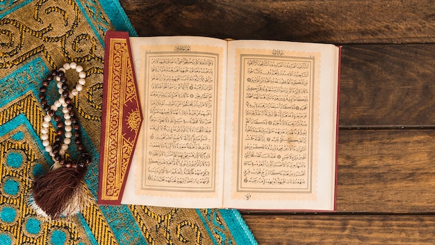 Photo quran near beads and patterned rag