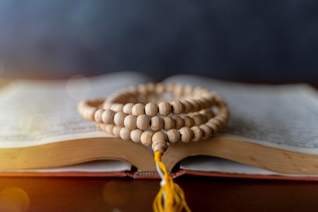 Quran with written arabic calligraphy meaning of Al Quran Ramadan Mubarak Ramadan kareem Holy Islamic Book Koran with rosary beads