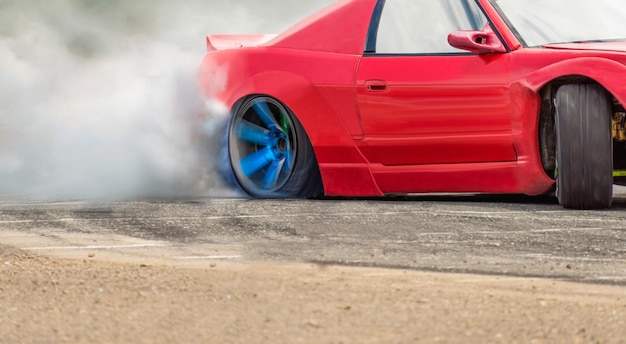 Race drift car burning tires on speed track