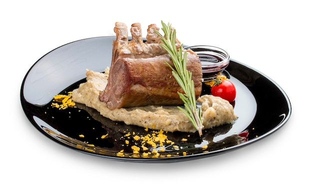 Rack of lamb with truffle puree on a black gloss plate