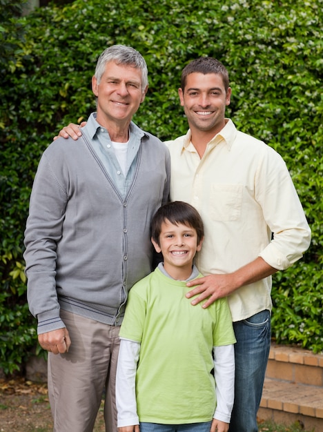 Radiant family looking at the camera in the garden