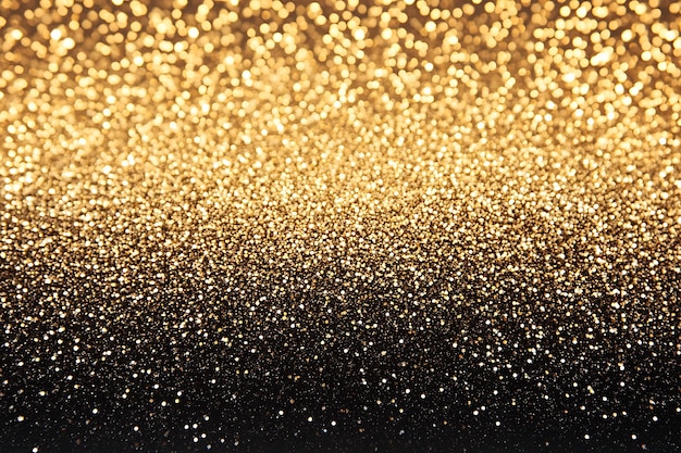 Radiant Golden Sparkles Glitter and Bokeh Lights on Dark Background for festive Holidays Banner