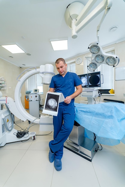 Radiologist or neurosurgeon is standing in hi tech modern operating room with robotic equipment. Up to date clinic.