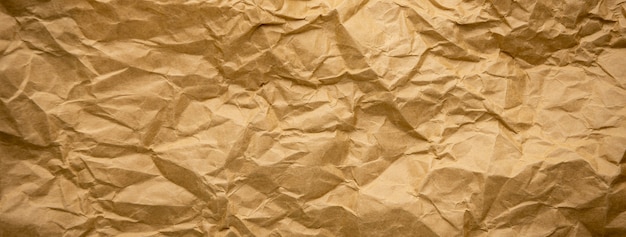 Ragged crumpled brown kraft paper texture banner background