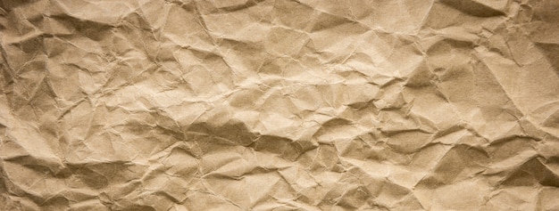 Ragged crumpled brown kraft paper texture banner background