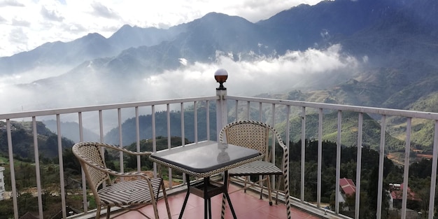 Railing on snowcapped mountain against sky