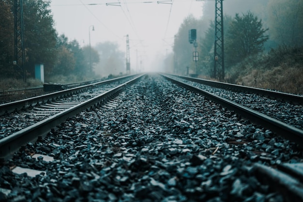 Railroad track rails in coutry landspace in autumn weather with foggy landscape Industrial concept Railroad travel railway tourism