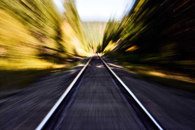 Photo railroad track with motion blur - railway leading through abstract nature