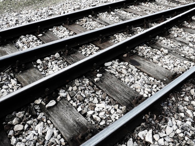 Rails and sleepers railroad and stones Railway traffic Perspective Metal rails with concrete sleepers Closeup Black and white monochrome