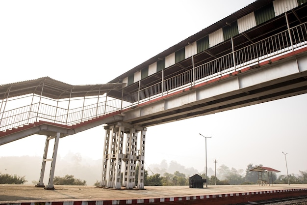 A railway foot over bridge in a station in the morning.