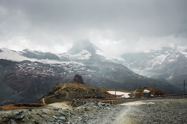 Railway in mountains Zermatt Swiss Alps adventure in Switzerland Europe Matterhorn with clouds