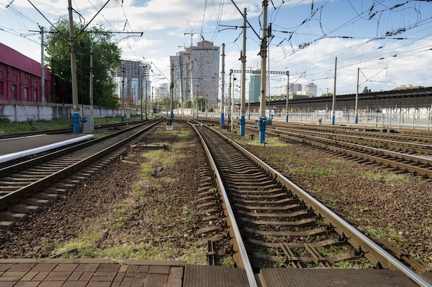 Railway in a residential area of the city among near high-rise buildings on a sunny day