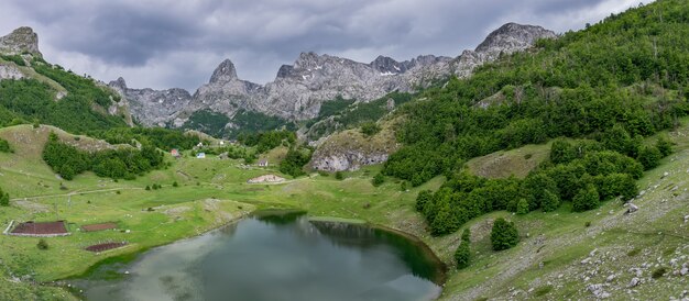 Rain clouds are approaching the mountain lake.