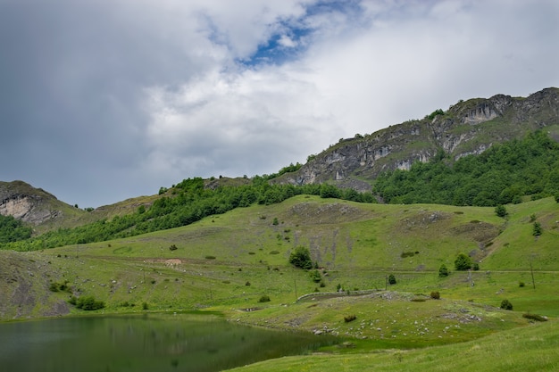 Rain clouds are approaching the mountain lake.