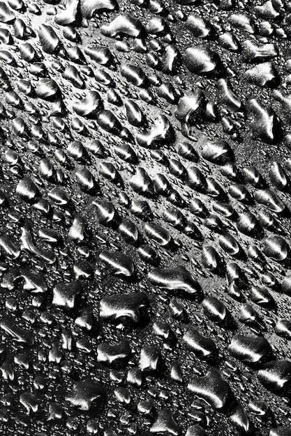 Rain drops on dark grey metallic wall