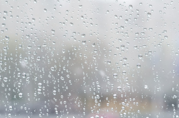 Rain drops and frozen water on window glass background