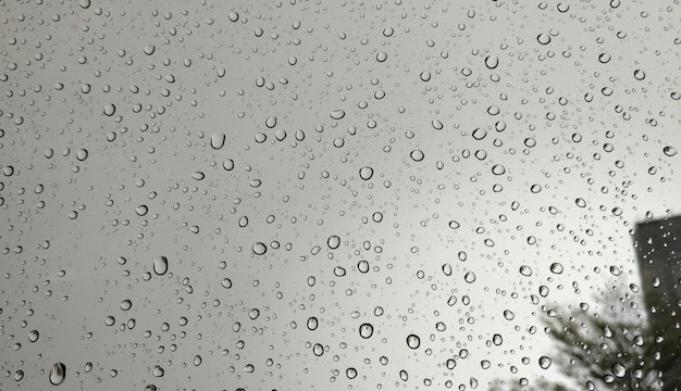 Rain drops on red glass window background