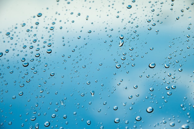 Rain drops on the windshield.