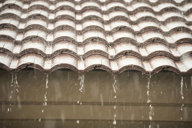 Rain falling down from the house roof