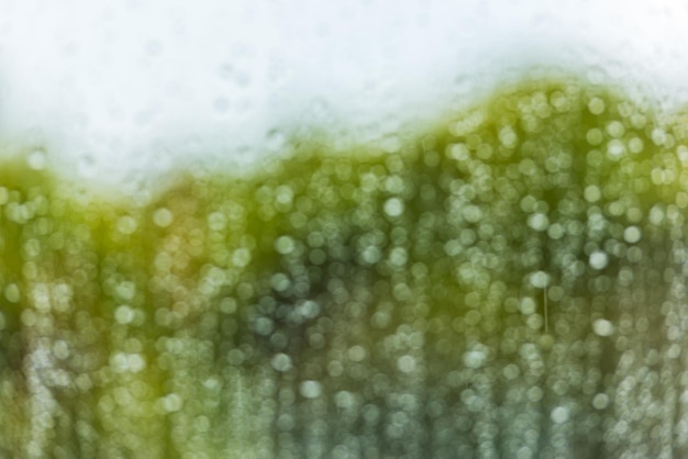 Rain water drops on a window glass defocused