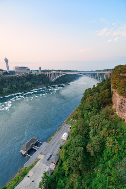 Rainbow Bridge over river at dusk