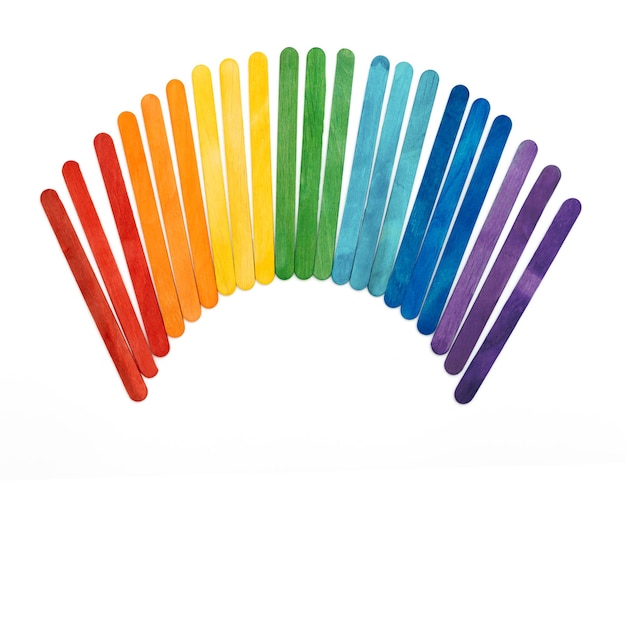 Rainbow color wooden ice cream sticks on white