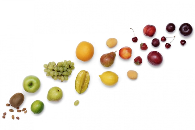 Rainbow colored fruit frame on a white table. Dieting, healthy food concept.