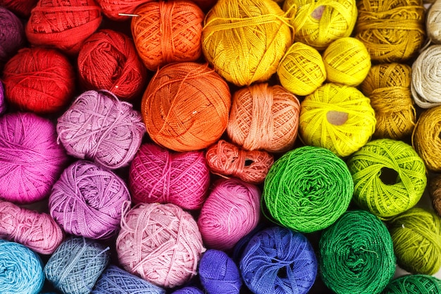 Rainbow colored yarn balls, viewed from above.