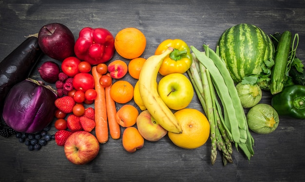 rainbow fruit and vegetables on wood