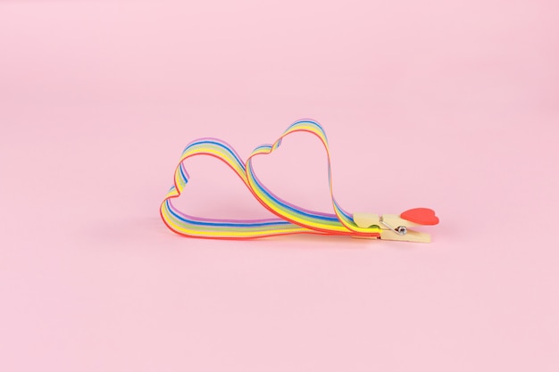 Rainbow ribbon awareness for LGBT community on pink